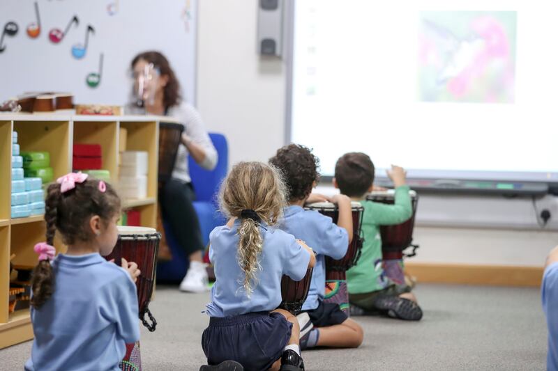 Kindergarten music class at the school, which now has a secondary school as well as a primary school.