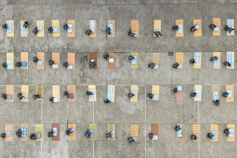 This aerial photo taken  shows university freshmen practicing folding quilts during a military education and training session on a university campus in Yangzhou in China's eastern Jiangsu province. AFP