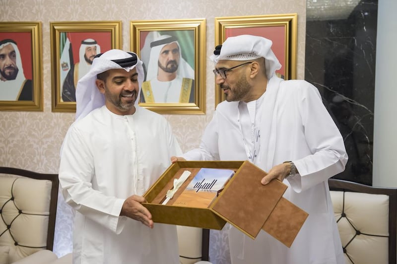 Sheikh Hamed bin Zayed, Chairman of Crown Prince Court - Abu Dhabi and Managing Director of the Abu Dhabi Investment Authority (ADIA), receives a gift from Dr. Jamal Al Suwaidi, Director General of the Emirates Center for Strategic Studies and Research (ECSSR) (R), during a visit to the Emirates Centre for Strategic Studies and Research (ECSSR). Mohamed Al Suwaidi / Crown Prince Court - Abu Dhabi