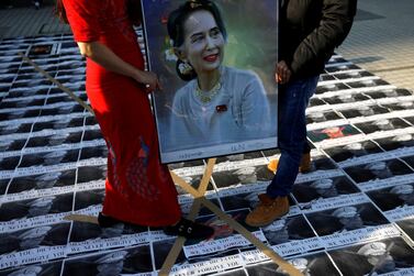 Myanmar protesters residing in Japan stand on pictures of Myanmar's army chief Min Aung Hlaing as they rally against the country's military after it seized power from a democratically elected civilian government. Reuters