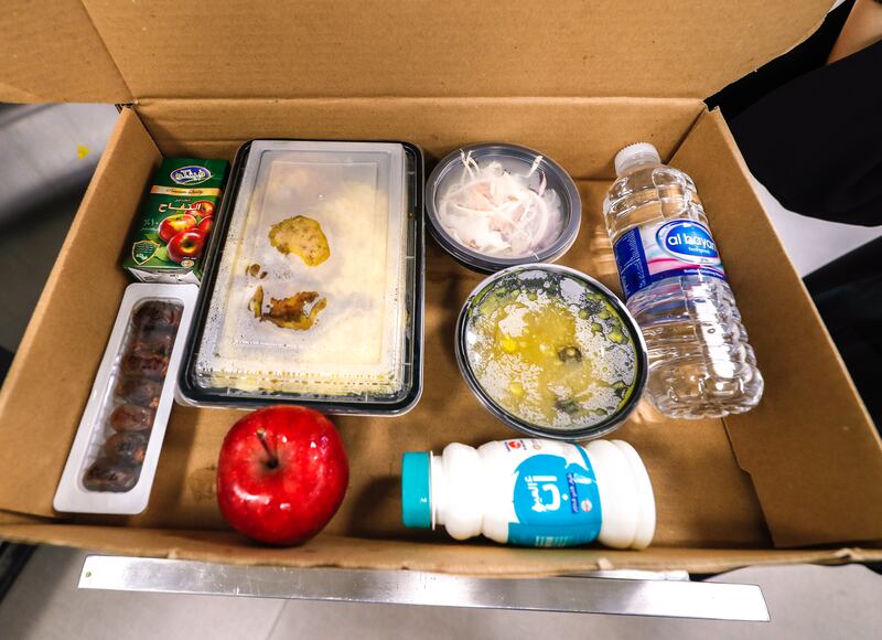 Each iftar box contains dates, laban, an apple, salad, juice and water. 