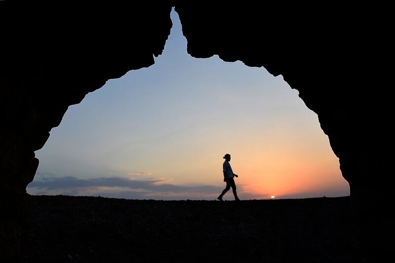 A man walks in the royal cemetary in the Great Ziggurat temple in the ancient city of Ur, ahead of the visit of Pope Francis to Iraq, in the southern province of Dhi Qar, around 375 kilometres southeast of the capital Baghdad, on March 3, 2021. - Pope Francis' historic visit from March 5 to 8 will include trips to Baghdad, the city of Mosul in the north and a meeting with the country's top Shiite cleric Grand Ayatollah Ali Sistani. (Photo by Asaad NIAZI / AFP)