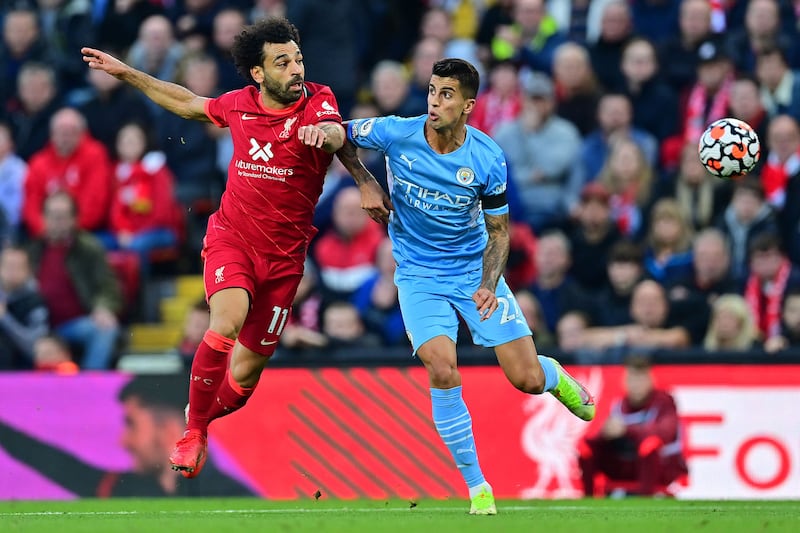 Liverpool's Mohamed Salah challenges Manchester City's Rodrigo. AFP