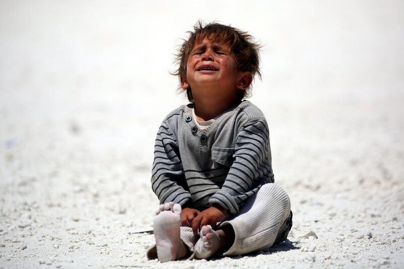 A displaced Syrian child cries at refugee camp in the northern Syrian village of Ain Issa.  Delil Souleiman / AFP Photo