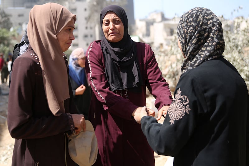 Palestinian women weep at the site of the hospital. AFP