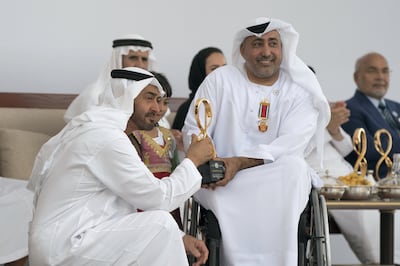 ABU DHABI, UNITED ARAB EMIRATES -  March 12, 2018: HH Sheikh Mohamed bin Zayed Al Nahyan, Crown Prince of Abu Dhabi and Deputy Supreme Commander of the UAE Armed Forces (L), presents an Abu Dhabi Award to Theban Salem Al Mheiri (R), during the awards ceremony at the Sea Palace. Seen with Dhabia Thaiban AlMheiri (C).

( Mohamed Al Hammadi / Crown Prince Court - Abu Dhabi )
—