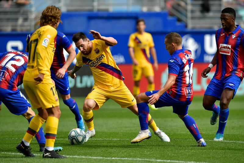 Barcelona's Lionel Messi, centre left, tries to get though the Eibar defence during a Spanish La Liga soccer match between Eibar and FC Barcelona at the Ipurua stadium in Eibar, Spain. AP Photo