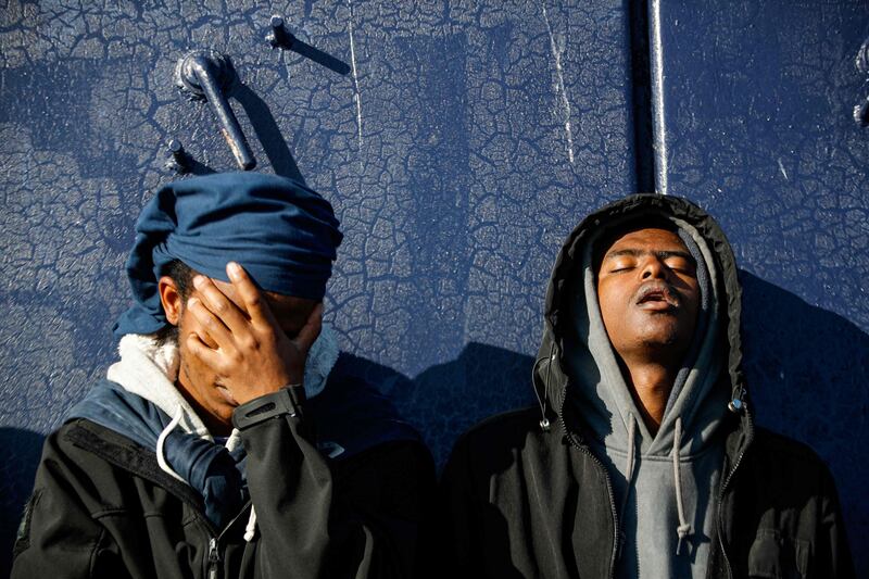 Migrants wait on board the 'Abeille Languedoc' ship after being rescued after their boat broke down in French waters. They were trying to cross the Channel to Britain. AFP