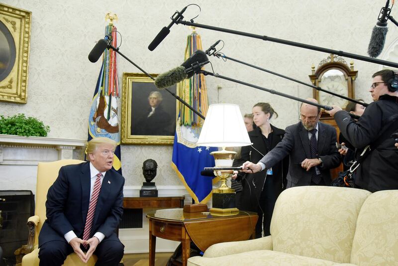 U.S. President Donald Trump responds to a question from members of the media during a meeting in the Oval Office of the White House in Washington, D.C., U.S., on Friday, Feb. 9, 2018. Trump during the meeting praised his former staff secretary, Rob Porter, for performing well in the White House and cautioned reporters to keep in mind that he has denied allegations of domestic violence. Photographer: Olivier Douliery/Pool via Bloomberg