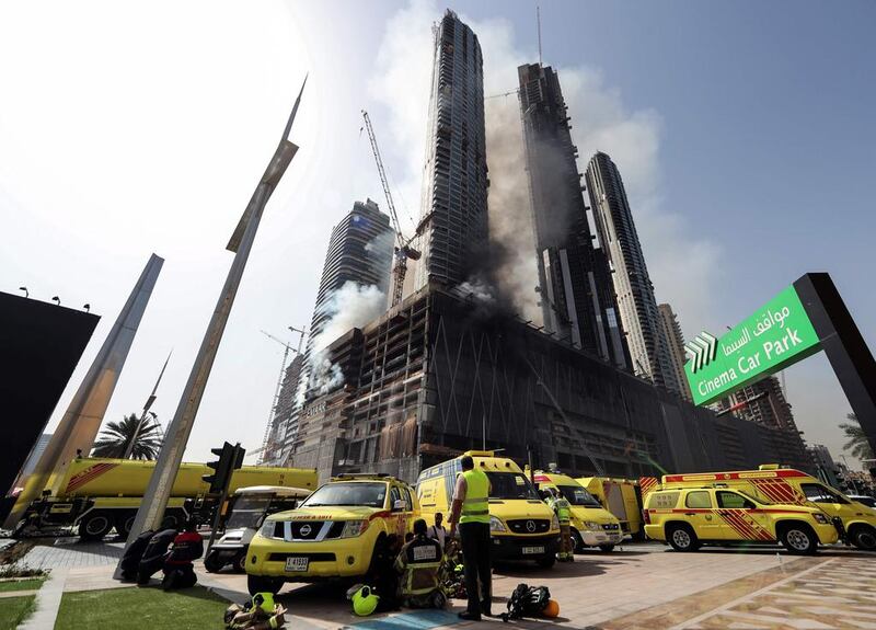Members of Dubai Civil Defence were quickly at the scene of the fire to rescue four workers trapped in the under-construction Fountain Views residential building Dubai Mall and the Burj Khalifa, the world’s tallest building. Karim Sahib / AFP