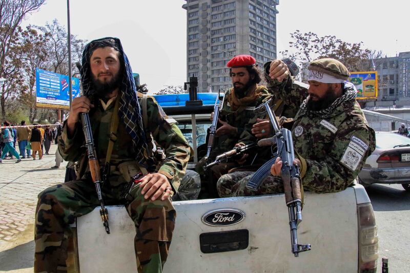 Taliban guards in Kabul in May, after the announcement of a decree that all Afghan women must wear full burqas in public. EPA