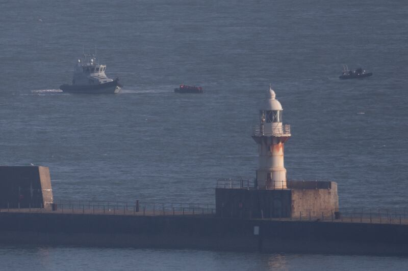 A boat carrying migrants is apprehended as it arrives in Dover, England. Getty Images