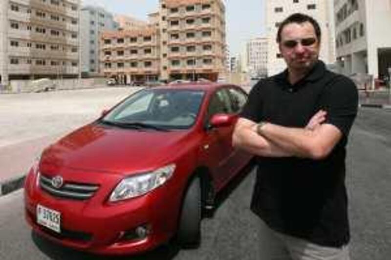 DUBAI- JULY 25,2009 - Simon Clough stand beside his rented car in Deira Dubai. ( Paulo Vecina/The National ) *** Local Caption ***  PV Simon 5.jpg