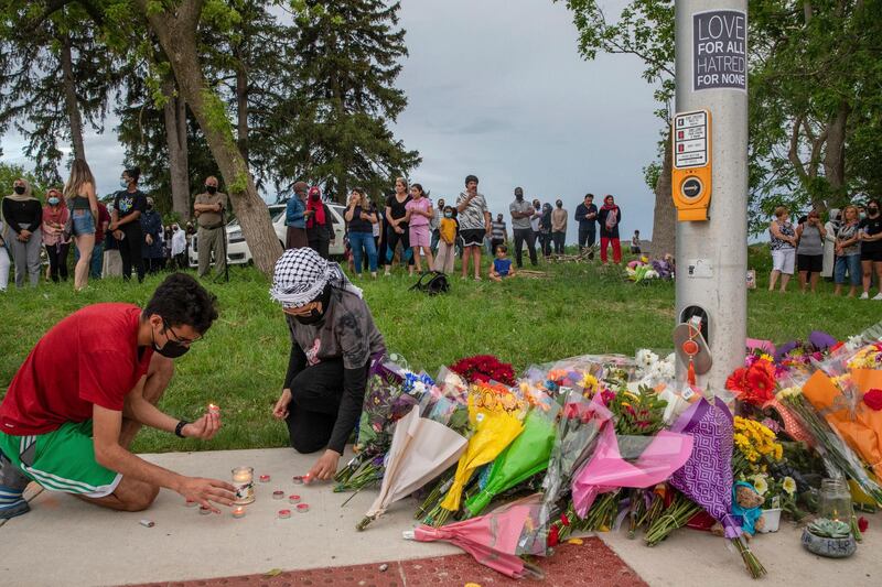 Abood, 18, left, and his sister Zeina Abdulhadi, 15, visit a memorial to the family of five hit by a driver, in London, Ontario, Canada. AP Photo