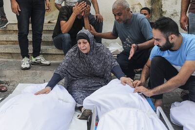 Palestinians mourn over the bodies of loved ones at Al Shefa hospital in Gaza City, on October 11. EPA 