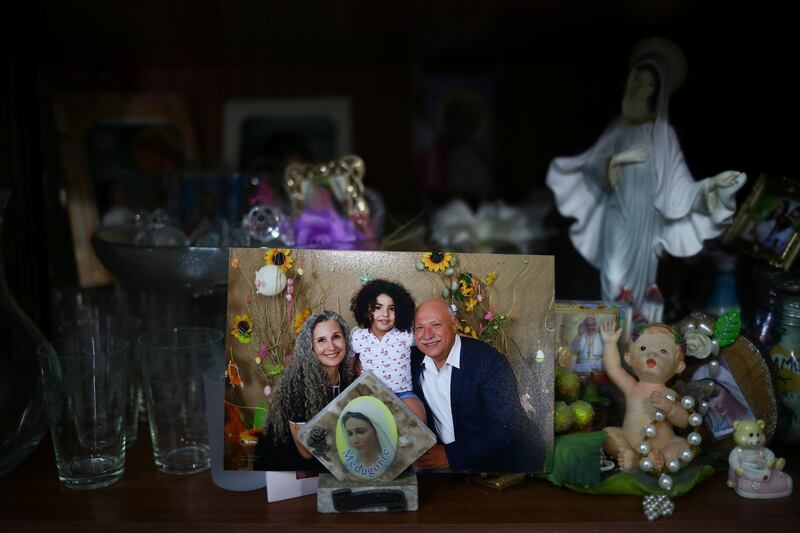 A photograph shows a missing silo employee Ghassan Hasrouty posing with his family. Reuters