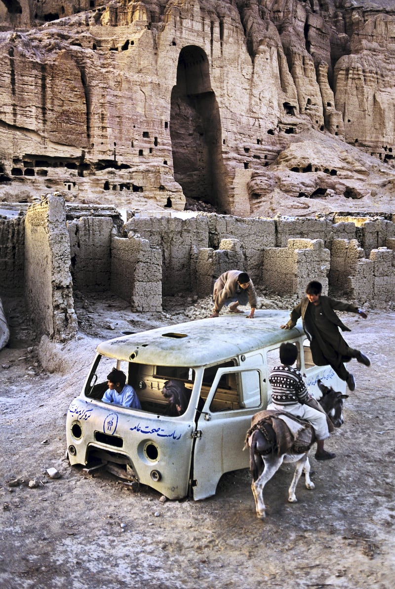 00624_20, AFGHN-12262, Bamiyan, Afghanistan, 2003. Boys play around an abandoned van.

MAX PRINT SIZE: 20x24"

Retouched_Sonny Fabbri 01/29/2017