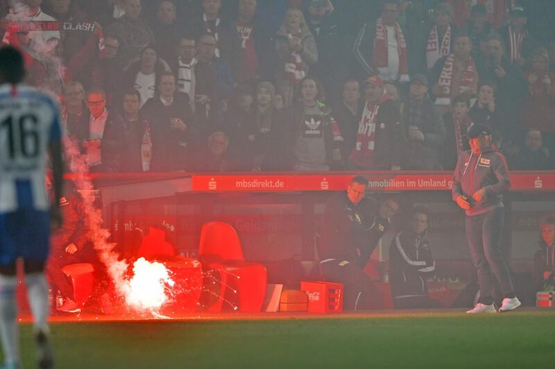 BERLIN, GERMANY - NOVEMBER 02: A firework lands infront of the substitutes bench of Union with head coach Urs Fischer (R) during the Bundesliga match between 1. FC Union Berlin and Hertha BSC at Stadion An der Alten Foersterei on November 02, 2019 in Berlin, Germany. (Photo by Thomas F. Starke/Bongarts/Getty Images)