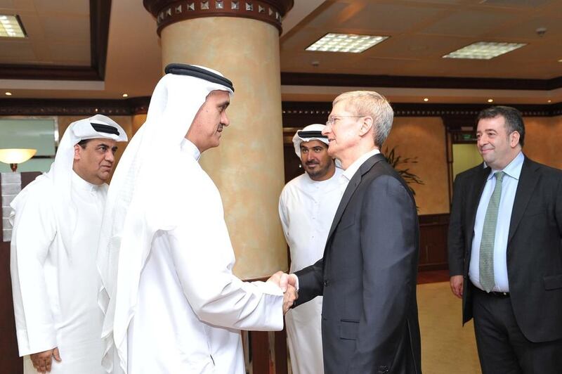 Apple's chief executive Tim Cook, right, meets Ahmad Julfar, chief executive of Etisalat Group. Courtesy Etisalat Group