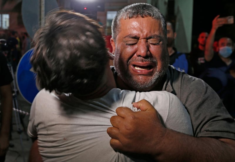 A Palestinian man cries at a hospital in Gaza City City, where those injured or killed in Israeli air strikes are transferred, on, May, 12, 2021. Gaza militants have launched more than 1,000 rockets since the beginning of this week according to Israel's army, which has carried out hundreds of air strikes in the crowded coastal enclave of Gaza. / AFP / Anas BABA
