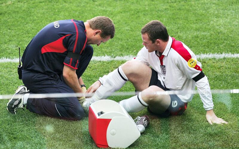 LISBON, PORTUGAL - JUNE 24:  Wayne Rooney of England gets treatment prior to leaving the pitch during the UEFA Euro 2004, Quarter Final match between Portugal and England at the Luz Stadium on June 24, 2004 in Lisbon, Portugal. (Photo by Laurence Griffiths/Getty Images)