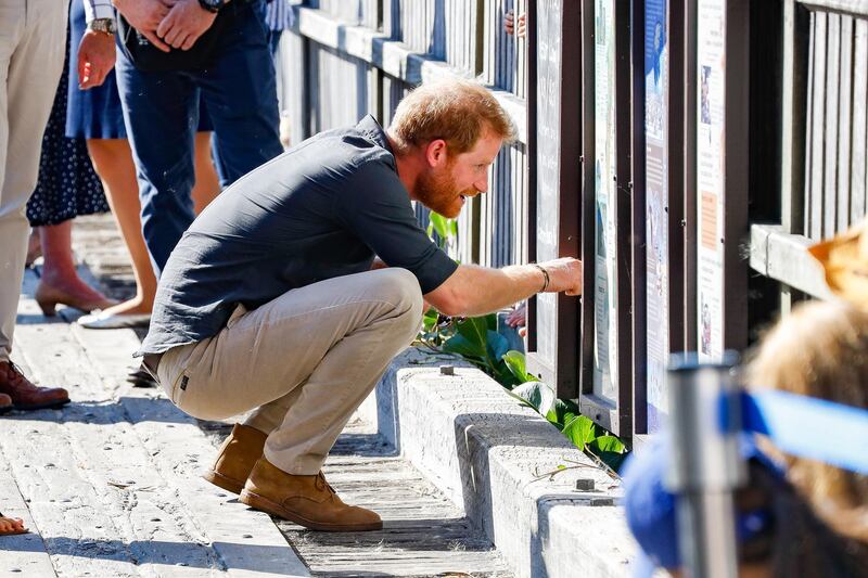 Prince Harry, Duke of Sussex crouches down to speak to a well-wisher. AFP Photo