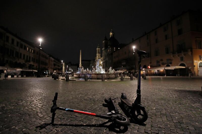 A view of an empty Piazza Navona Square after the start of a curfew. Italian Premier Giuseppe Conte, who imposed severe stay-at-home limits on citizens early on, then gradually eased travel and other restrictions, has been leaving it up to regional governors to order restrictions such as overnight curfews, including in places like Rome, Milan and Naples. AP
