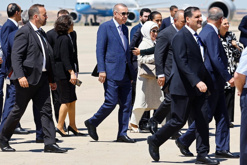 Mr Erdogan, centre, arrives at the Torreon air base in Madrid. AP