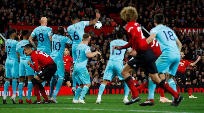 Juan Mata scores a free kick to make the score 2-1 against Newcastle United. Reuters