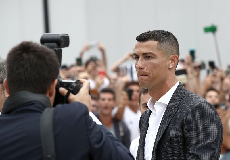 Ronaldo walks out the Juventus medical center to greet supporters. AFP