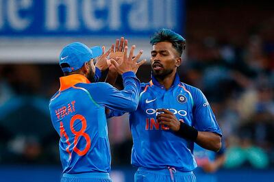 India captain Virat Kohli (L) celebrates with bowler Hardik Pandya (R) after the  dismissal of South Africa batsman JP Duminy (unseen) during the fifth One Day International cricket match between South Africa and India at Saint George Park, in Port Elizabeth, on February 13, 2018. / AFP PHOTO / MARCO LONGARI