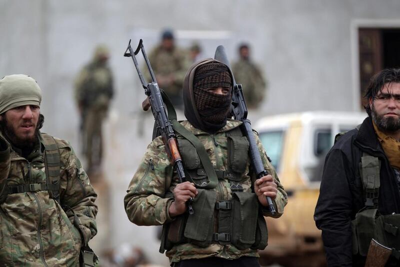 A rebel fighter carries his weapons on the outskirts of the northern Syrian town of Al Bab on January 15, 2017. Khalil Ashawi / Reuters