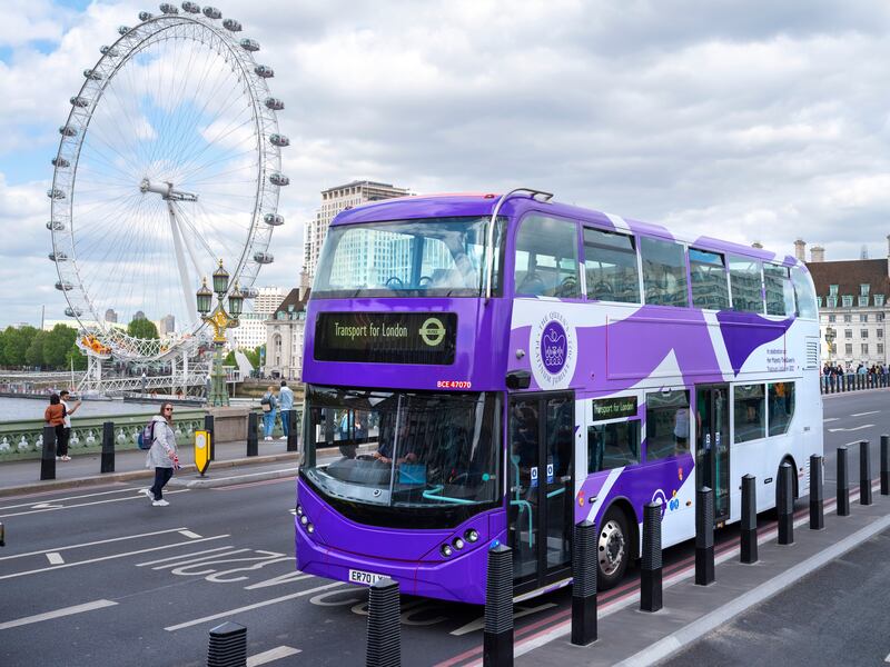 One of eight London buses given a purple makeover to celebrate the jubilee makes its way across central London. PA
