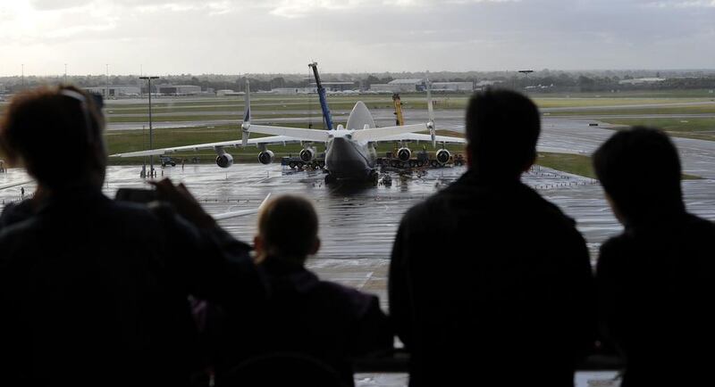 Spectators look out from an indoor viewing room at Perth Airport. Greg Wood / AFP
