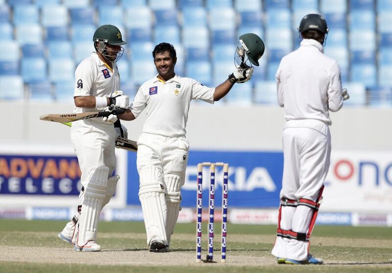 Pakistan’s Asad Shafiq, right, is congratulated by his captain Misbah-ul-Haq on his reaching the century milestone. Hassan Ammar / AP Photo