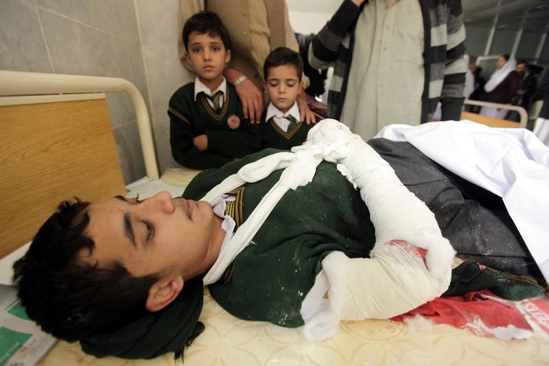A school boy who was injured in a Taliban attack receives medical treatment at a hospital in Peshawar. Arshad Arbab / EPA
