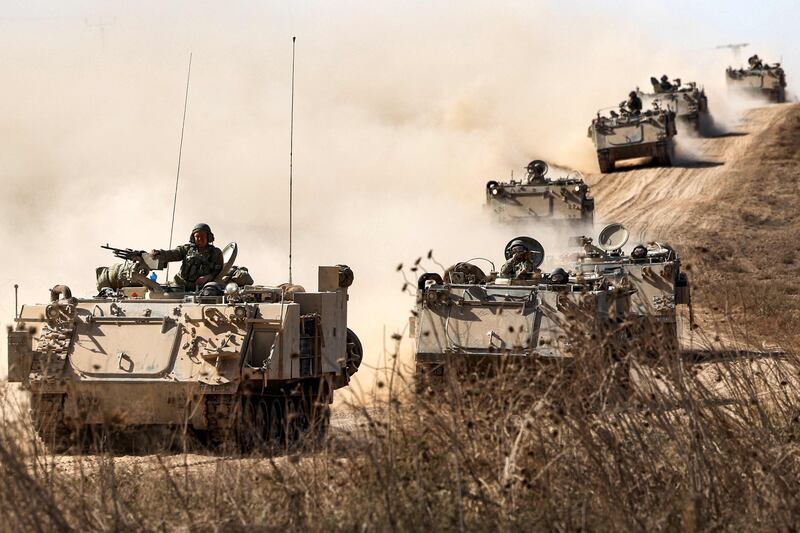 Israeli army infantry fighting vehicles deploy along the border with the Gaza Strip in southern Israel. AFP