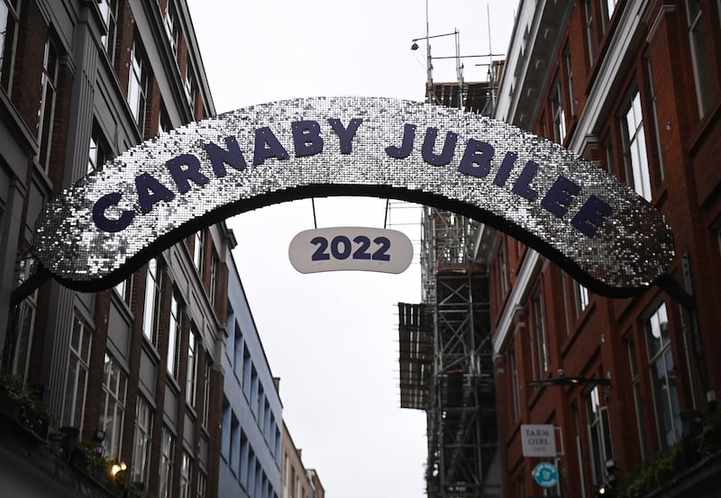 A glittering banner stretches across Carnaby Street shopping district in London. EPA