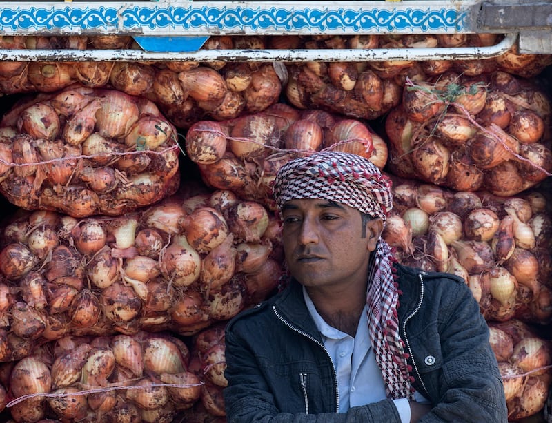 A vendor awaits customers at Amman Central fruits and vegetable market, Amman, Jordan, on April 8, 2020. EPA