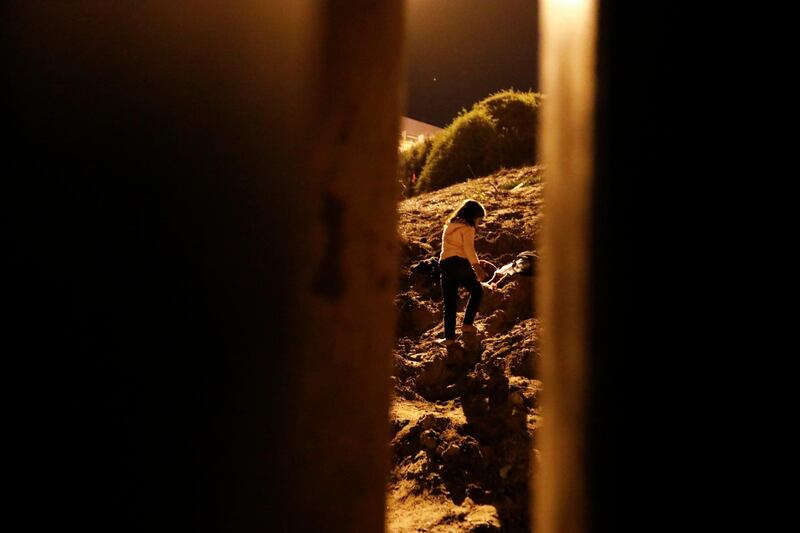 Alondra Rios Caseras, 7, walks up a hill to meet waiting US border patrol agents after she, her parents, and her two sisters crossed over the border fence. AP Photo