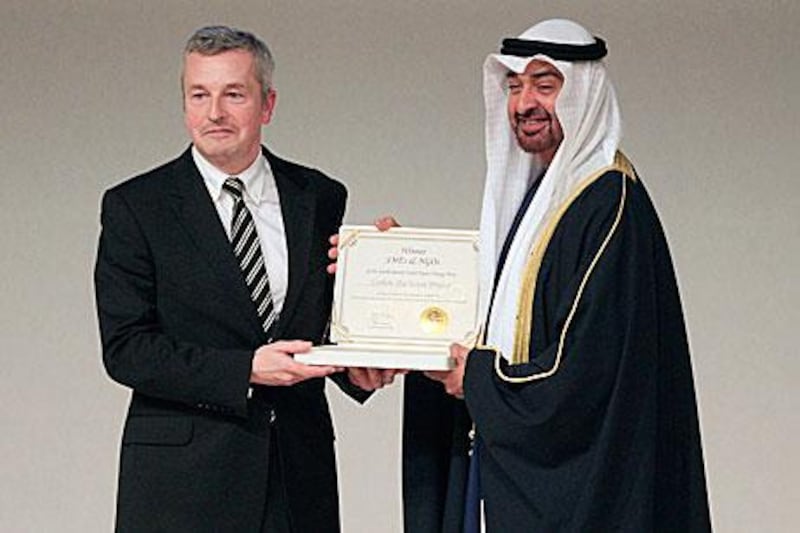 Sheikh Mohammed bin Zayed, Crown Prince of Abu Dhabi and Deputy Supreme Commander of the UAE Armed Forces, presents the Zayed Future Energy Award to Paul Dickinson, the executive chairman of the Carbon Disclosure Project for its pioneering use of market-based tools to solve environmental issues.