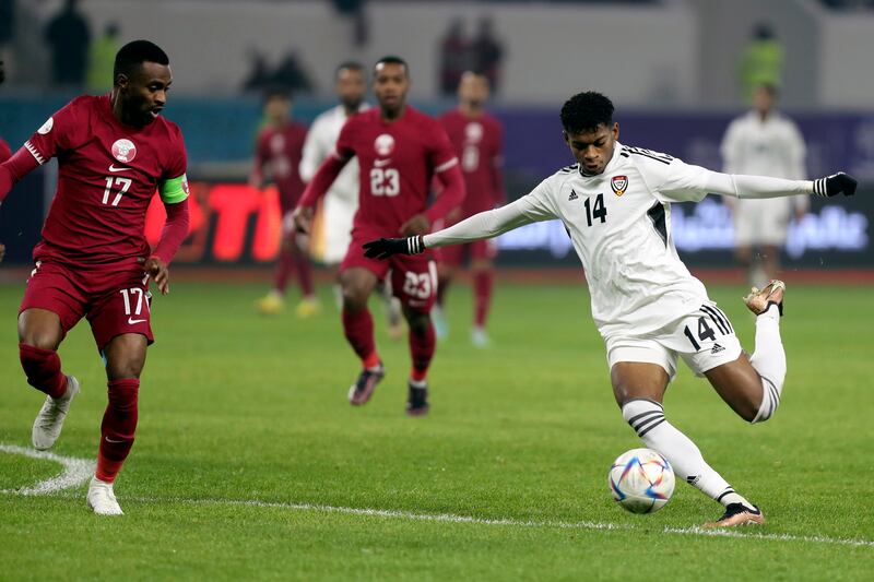 UAE's Yahya Al Ghassani, right, and Qatar's Ismail Mohammed, left, fight for the ball in Basra, Iraq. AP