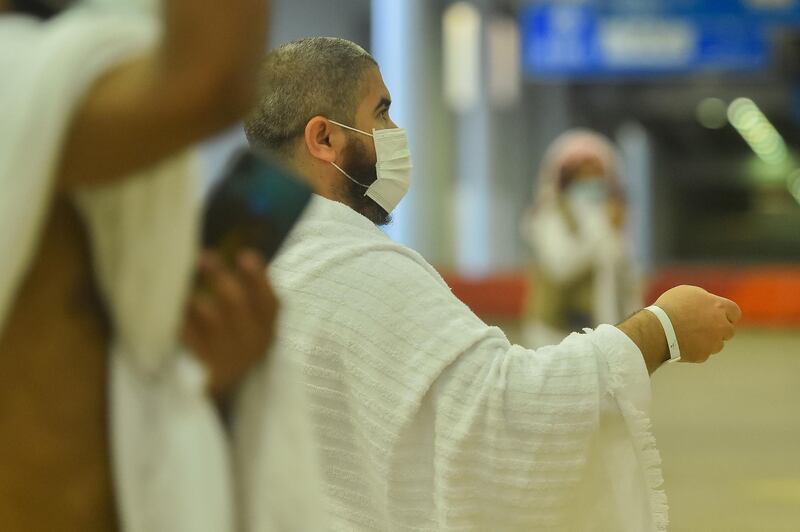 A Muslim pilgrim casts stones at pillars symbolising the devil in Mina. Saudi Press Agency / Reuters