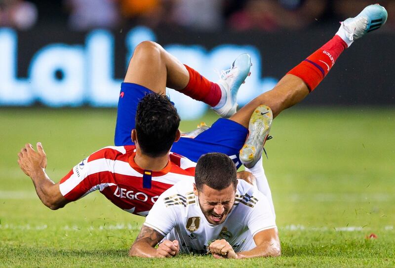 Diego Costa, left, collides with Real Madrid's Eden Hazard. EPA