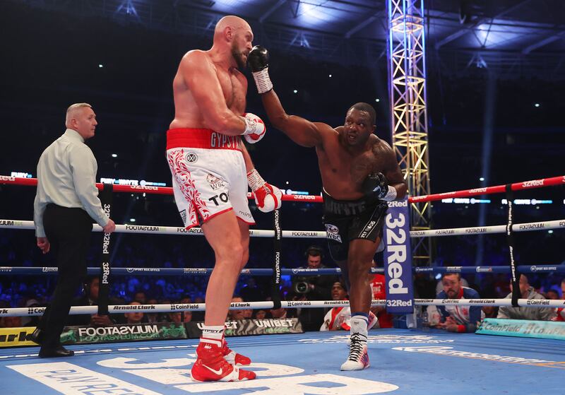 Dillian Whyte lands a reaching cross on Tyson Fury during their WBC world heavyweight title fight. Getty