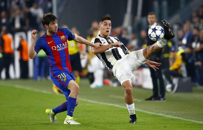 Juventus'w Paulo Dybala in action with Barcelona's Sergi Roberto. Stefano Rellandini / Reuters