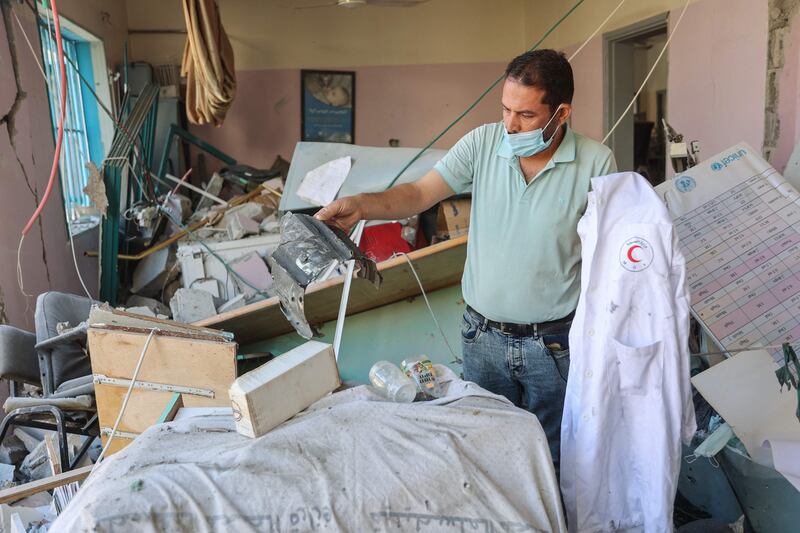 Palestinians inspect the damage at a clinic in Gaza city after it was hit by an Israeli strike. AFP