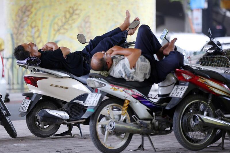 motorbike drivers take a nap at a street in Hanoi. Vietnam’s inflation rate increased 1.62 per cent in the first seven months of 2014, considered as the lowest rate in the last 13 years. Luong Thai Linh / EPA