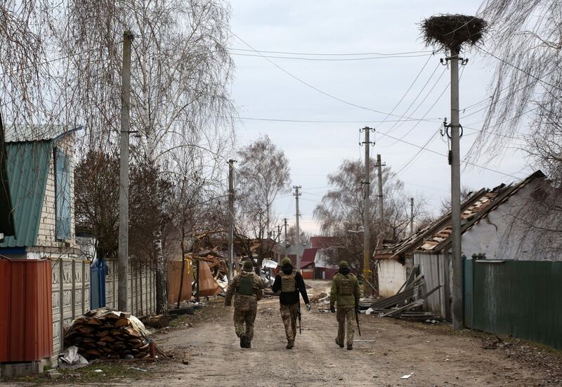 Ukrainian soldiers patrol a village on the frontline of the northern part of Kyiv region on March 28. AFP