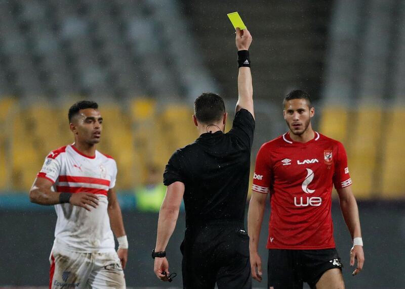 Al Ahly's Ramadan Sobhi is shown a yellow card by referee Istavan Kovacs. Reuters